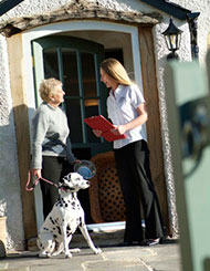 Photo of customer and dog volunteer talking about franchising