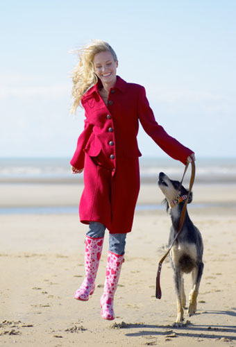 Photo of dog sitter taking dog for a walk in Spring